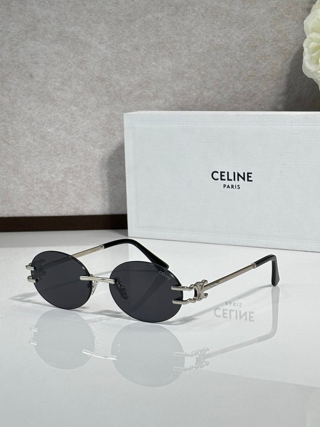 Celine sunglasses with dark gray round lenses and metal frames, gold-tone accents