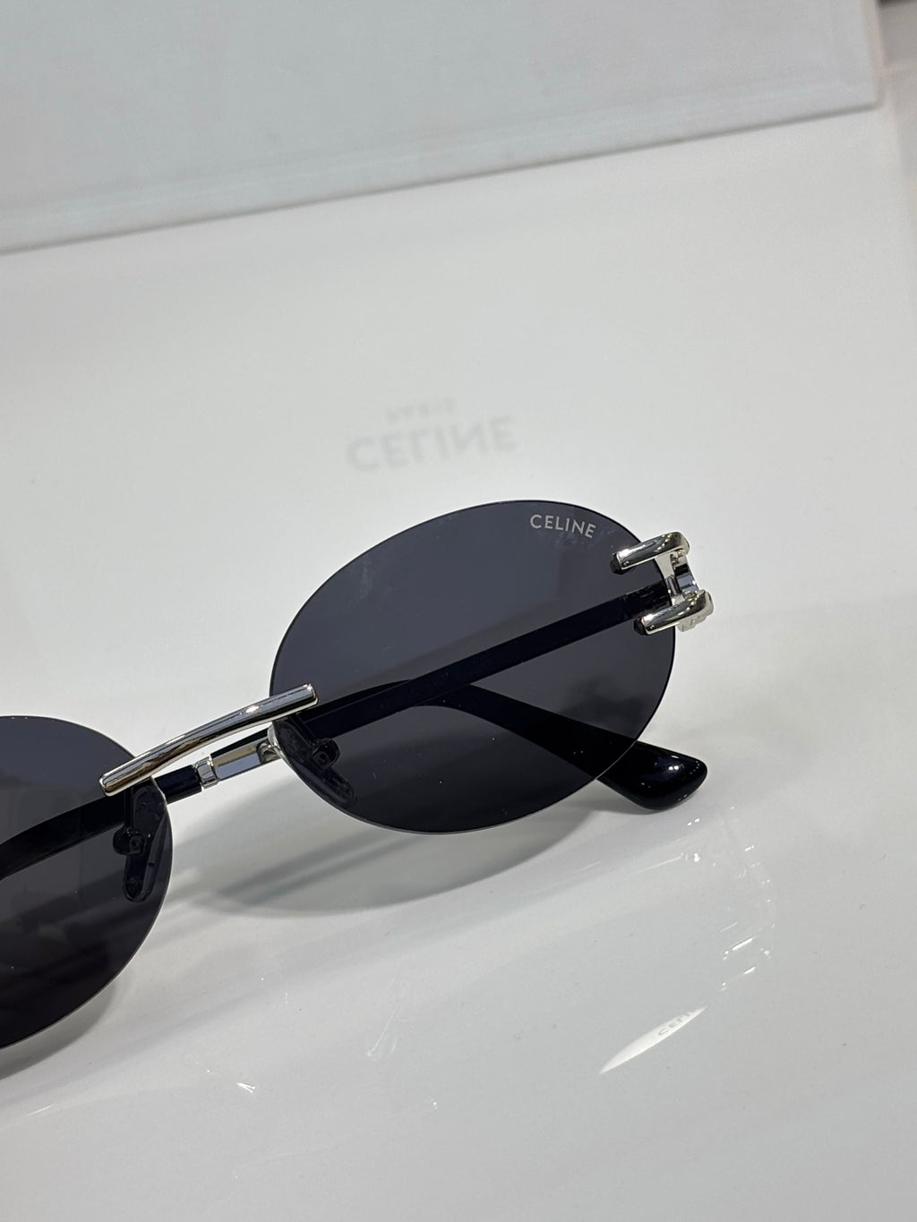 Celine sunglasses side view with dark lenses, silver-tone hinges, round frame