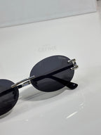 Celine sunglasses side view with dark lenses, silver-tone hinges, round frame
