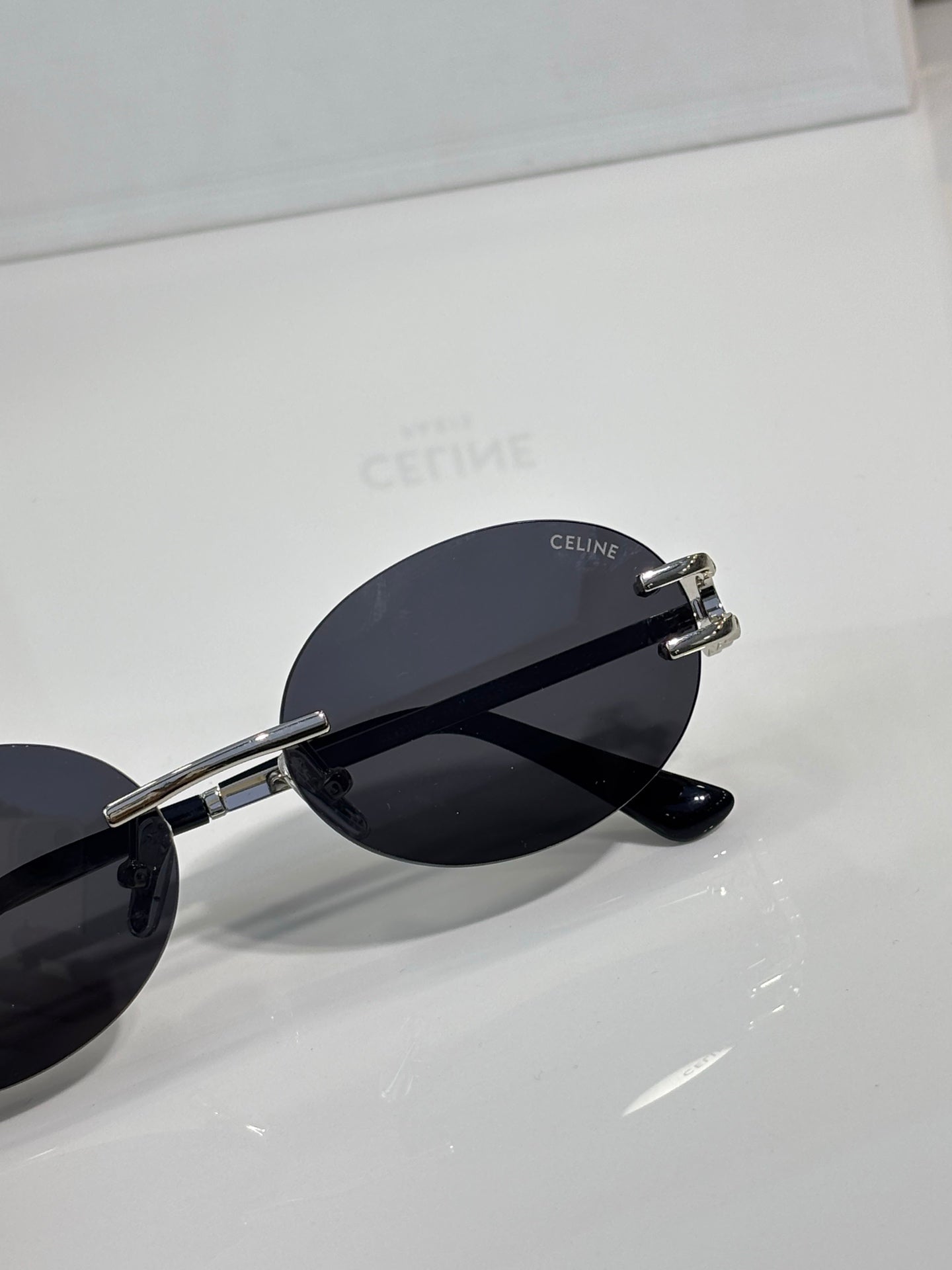 Celine sunglasses side view with dark lenses, silver-tone hinges, round frame