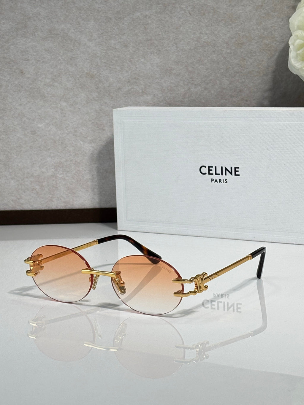 Celine sunglasses with amber round lenses and gold-tone metal frame, tinted temples