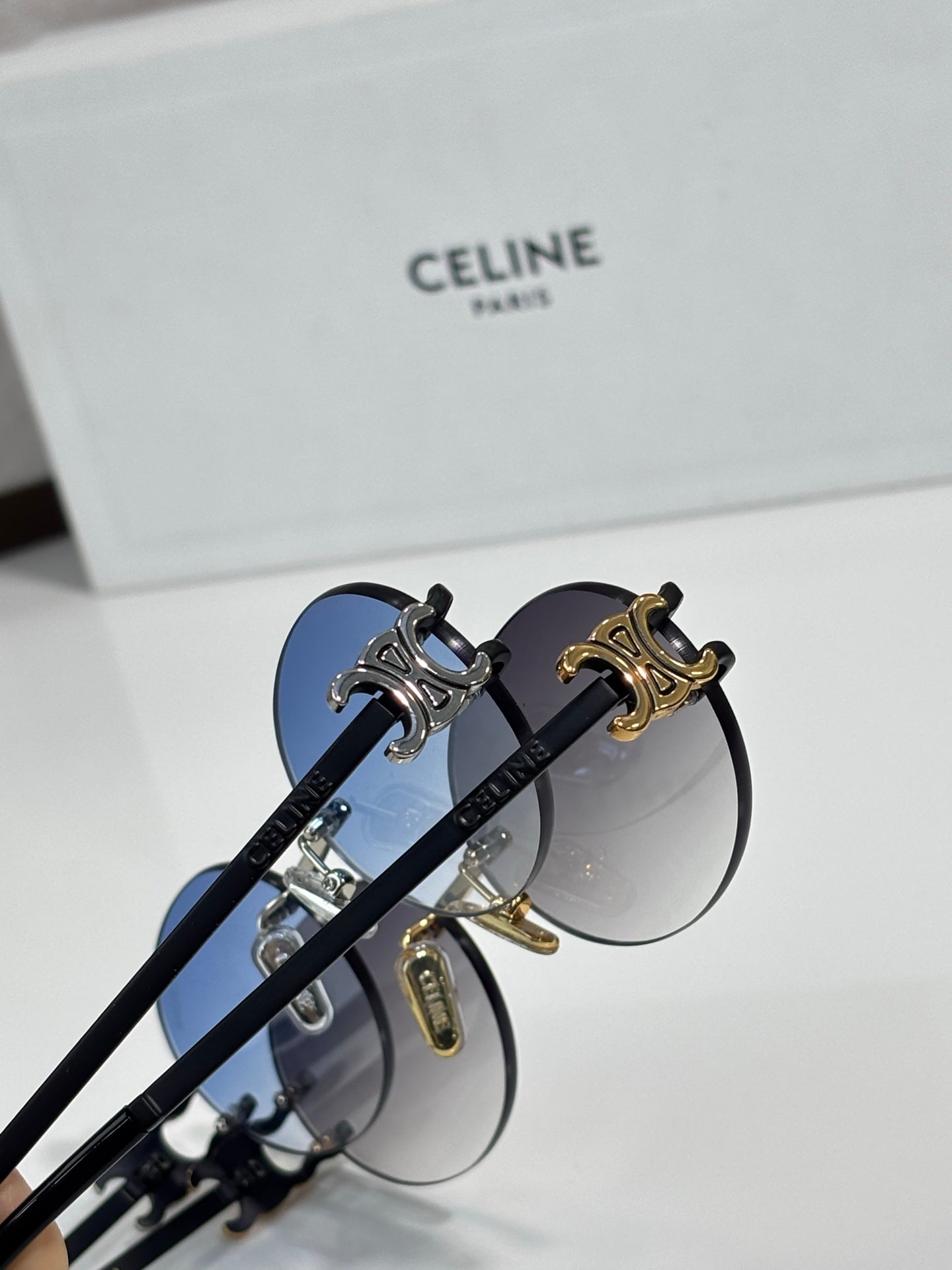 Celine sunglasses with blue lenses and ornate gold-and-silver temple hardware