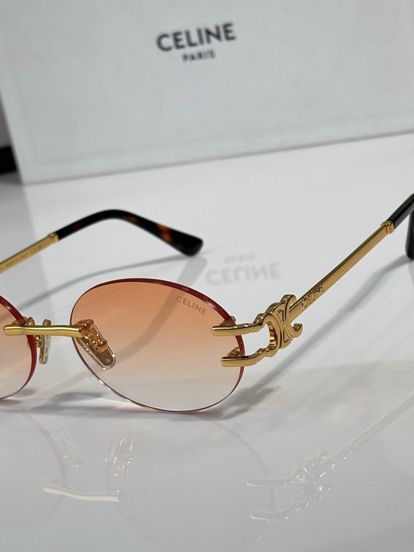 Celine sunglasses close view of amber round lenses with gold bridge hardware