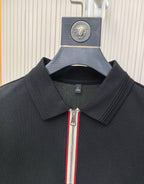 Black polo shirt collar with zip pull and vertical stripe trim.