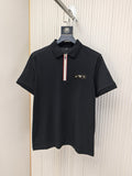 Black short-sleeve polo shirt with zip placket and small logo on chest.