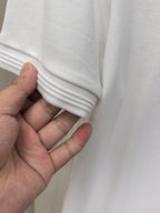 White polo shirt cuff and knit hem close-up