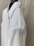 White polo shirt side view with textured fabric and zipper collar