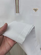 White polo shirt sleeve cuff with stitched hem and Prada chest logo
