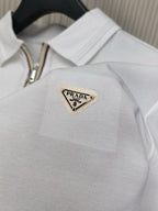 White polo shirt collar area with Prada triangle logo patch