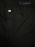Black pants waistband with Louis Vuitton label and metal button closure