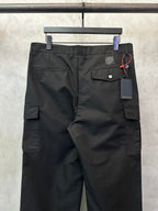 Black cargo pants back view with button pocket flap and hanging tag