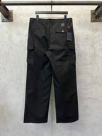 Black cargo pants front view with cargo pockets and hanging price tag