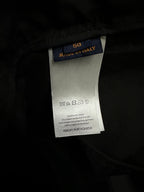 Black pants care and size tag showing “MADE IN ITALY” and “50”