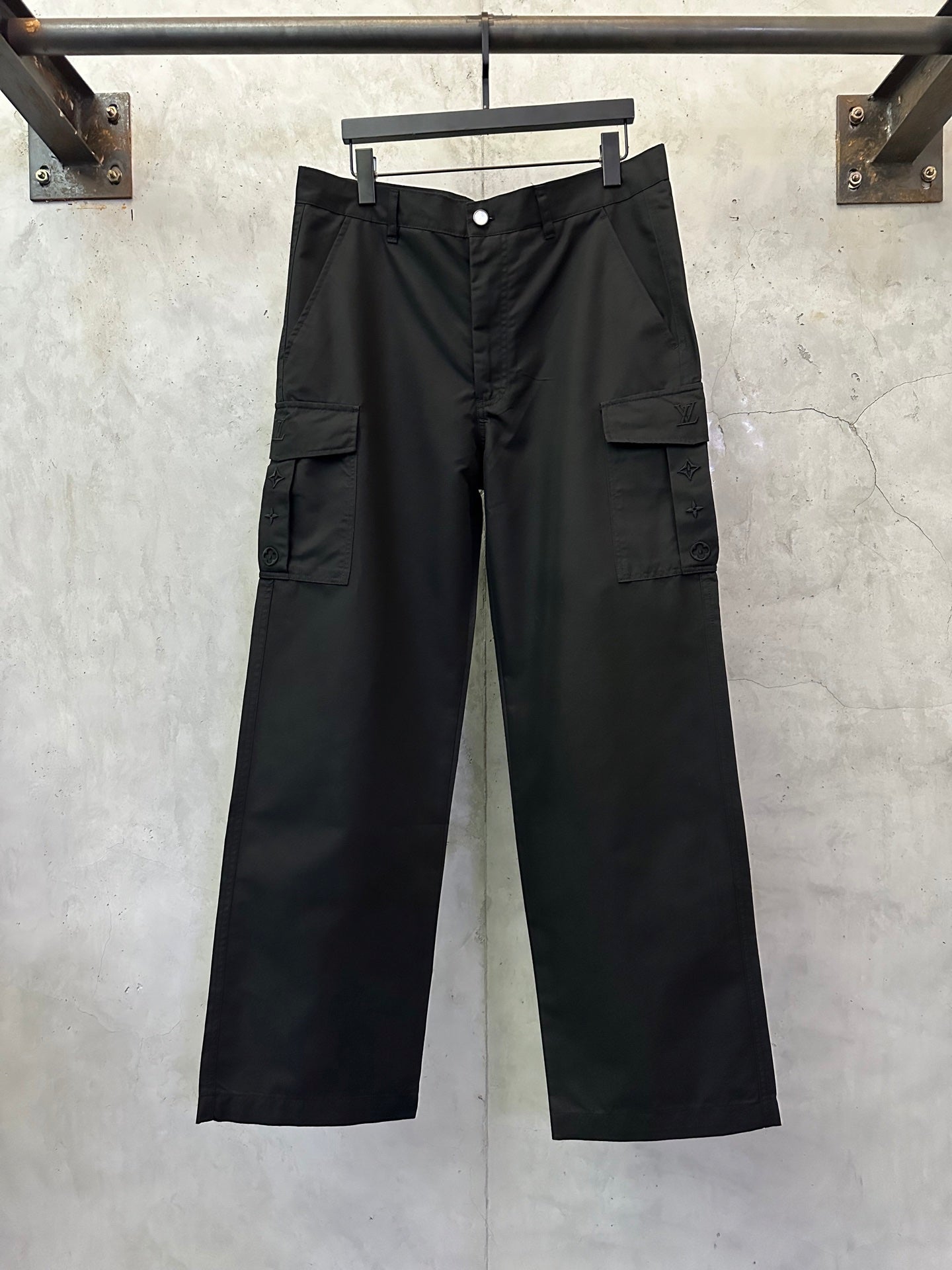 Black cargo pants with button closure, belt loops, and side cargo pockets