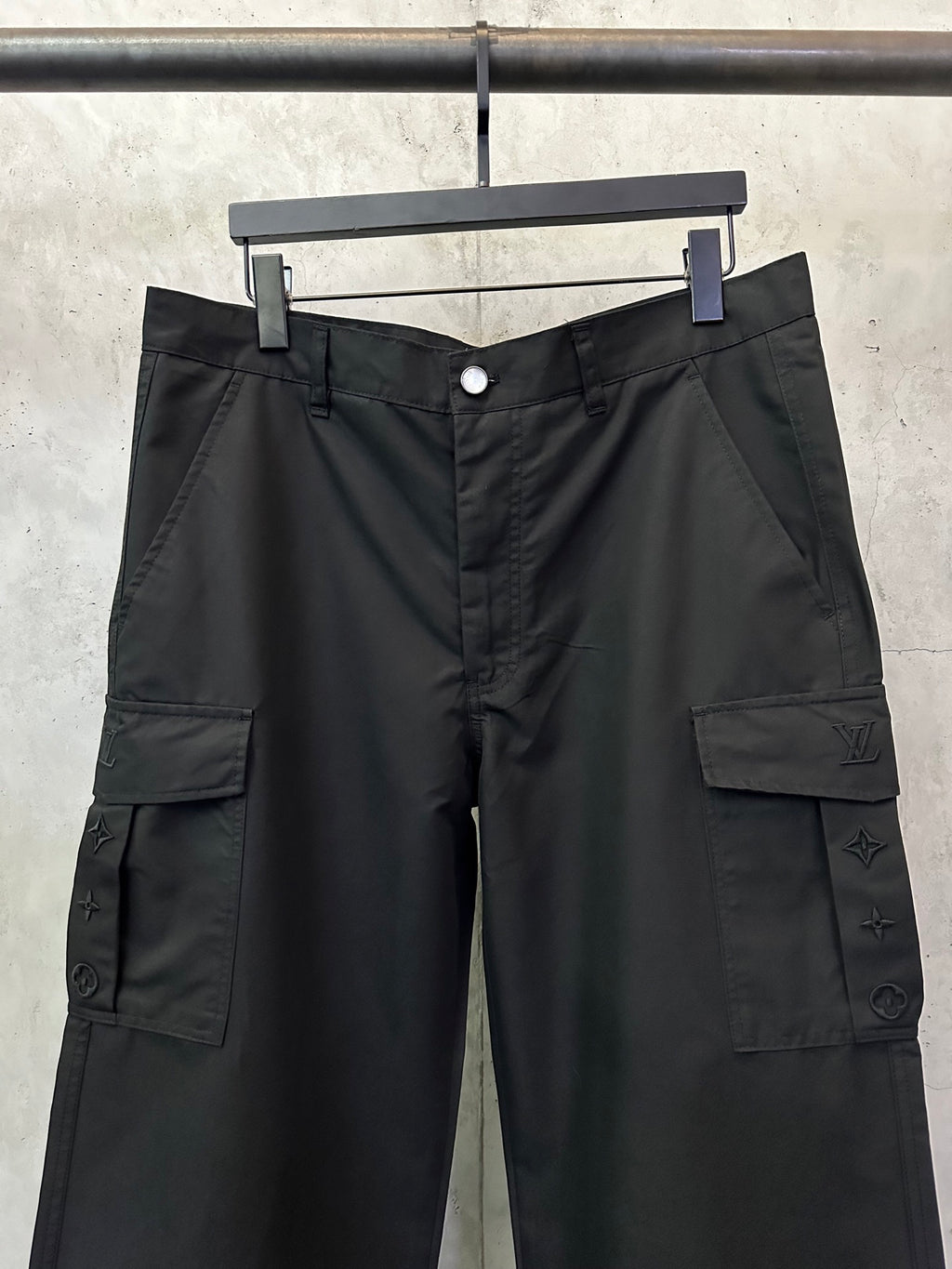 Black cargo pants with waistband button, belt loops, and front cargo pockets
