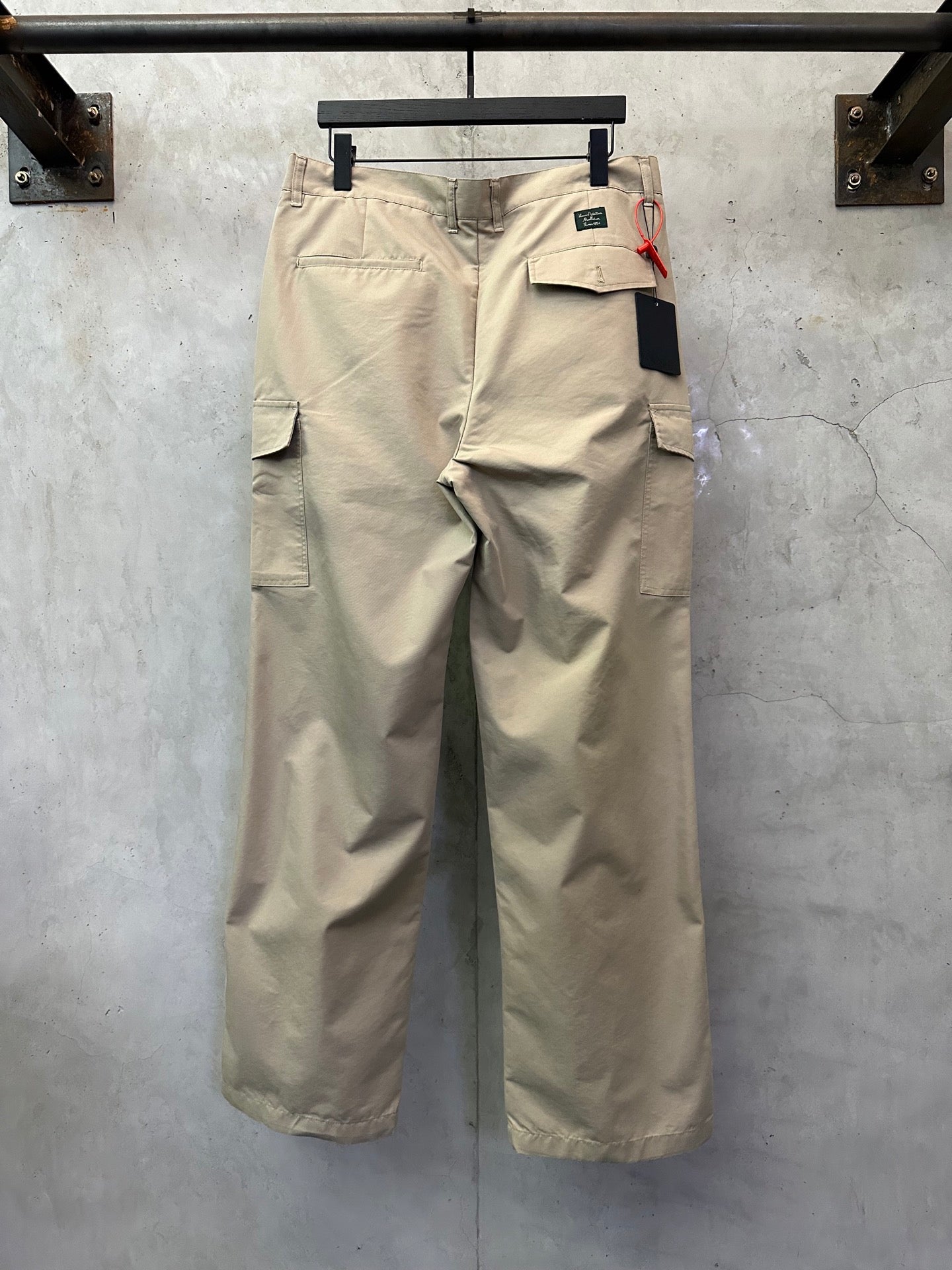 Beige cargo pants with back flap pockets and belt loop