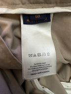 Beige pants care label with size 50 and wash instructions
