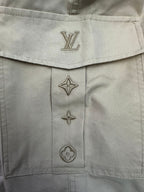 Beige pants button placket with Louis Vuitton monogram and star emblems