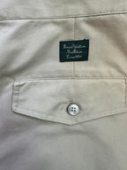Beige pants waistband with Louis Vuitton Material tag and button