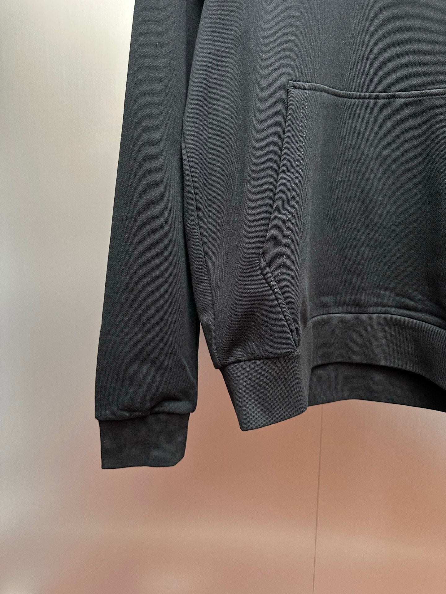 Moncler dark gray hoodie side view with kangaroo pocket opening