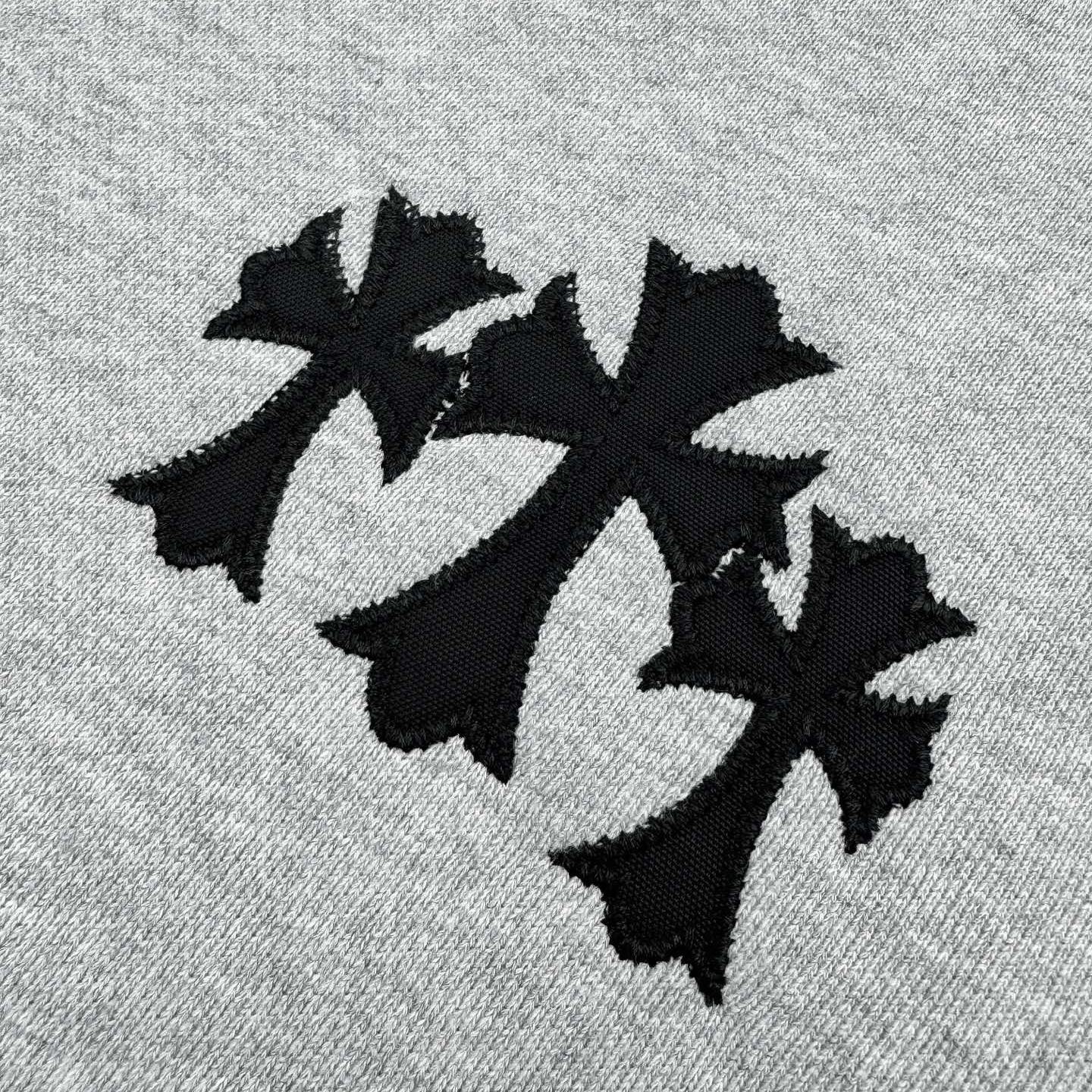 Black applique-style star graphic on heather gray sweatshirt