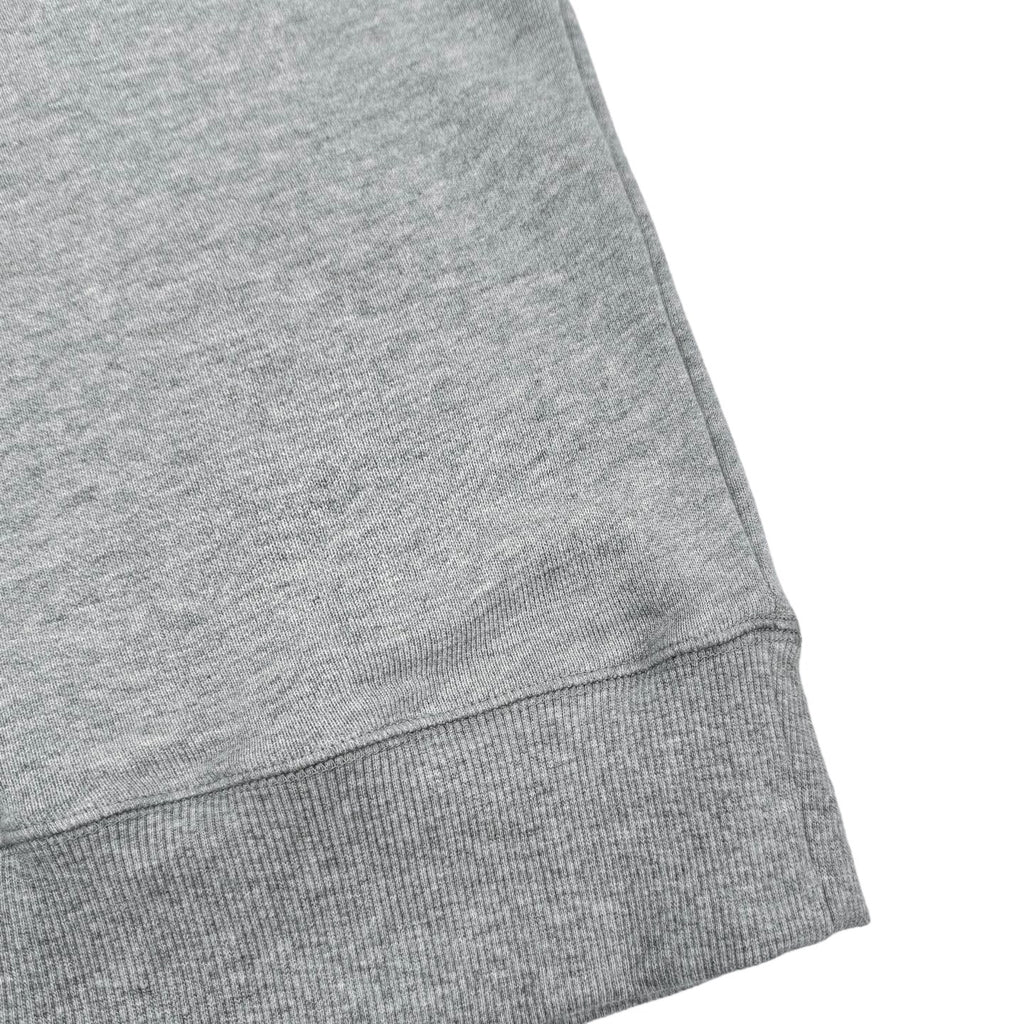 Heather gray sweatshirt hem with ribbed trim and stitched seams