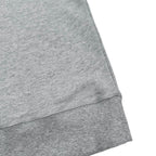 Heather gray sweatshirt hem with ribbed trim and stitched seams
