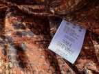 Orange-brown snake-print lining with white size and care label tag
