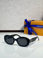 Black round sunglasses with dark lenses and gold LV logo on temple