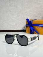 Louis Vuitton sunglasses with black frames and dark lenses, gold hinge and logo
