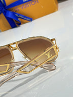 Louis Vuitton sunglasses with gold frames and brown gradient lenses, close-up