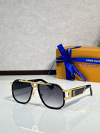 Louis Vuitton sunglasses with black frames, dark tinted lenses, gold trim on arms