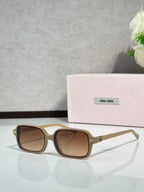 MiuMiu sunglasses with tan frames and brown tinted lenses