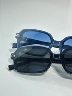 MiuMiu sunglasses close-up with dark blue frames and blue tinted lenses