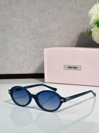 Miu Miu glasses, navy round frames with gold-tone logo details