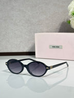 Miu Miu glasses, black round frames with dark lenses