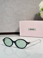 Miu Miu glasses, dark teal round frames with gold-tone logo details