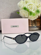 Miu Miu glasses, dark round frames with navy-tinted lenses