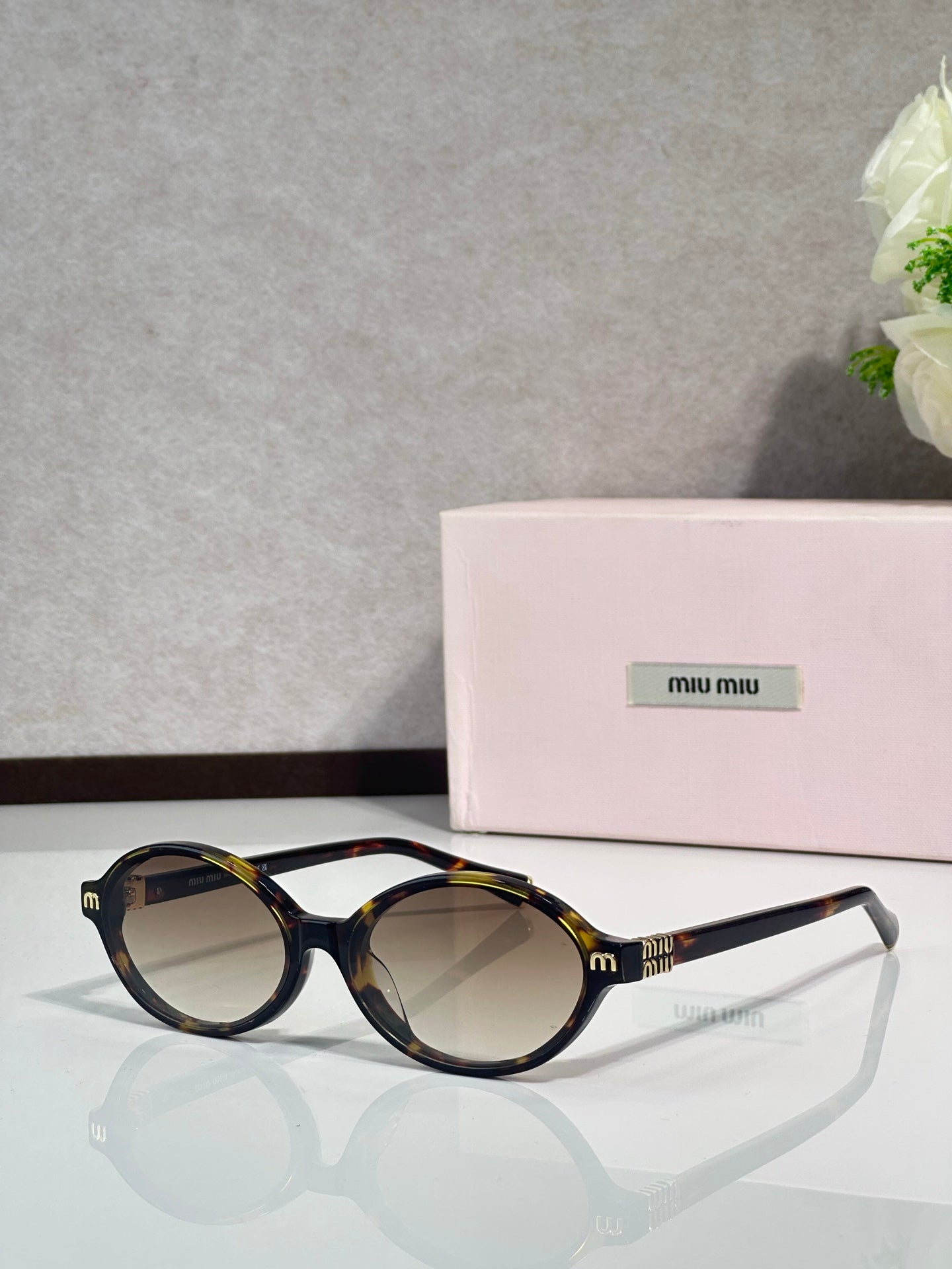 Miu Miu glasses, tortoiseshell round frames with dark lenses