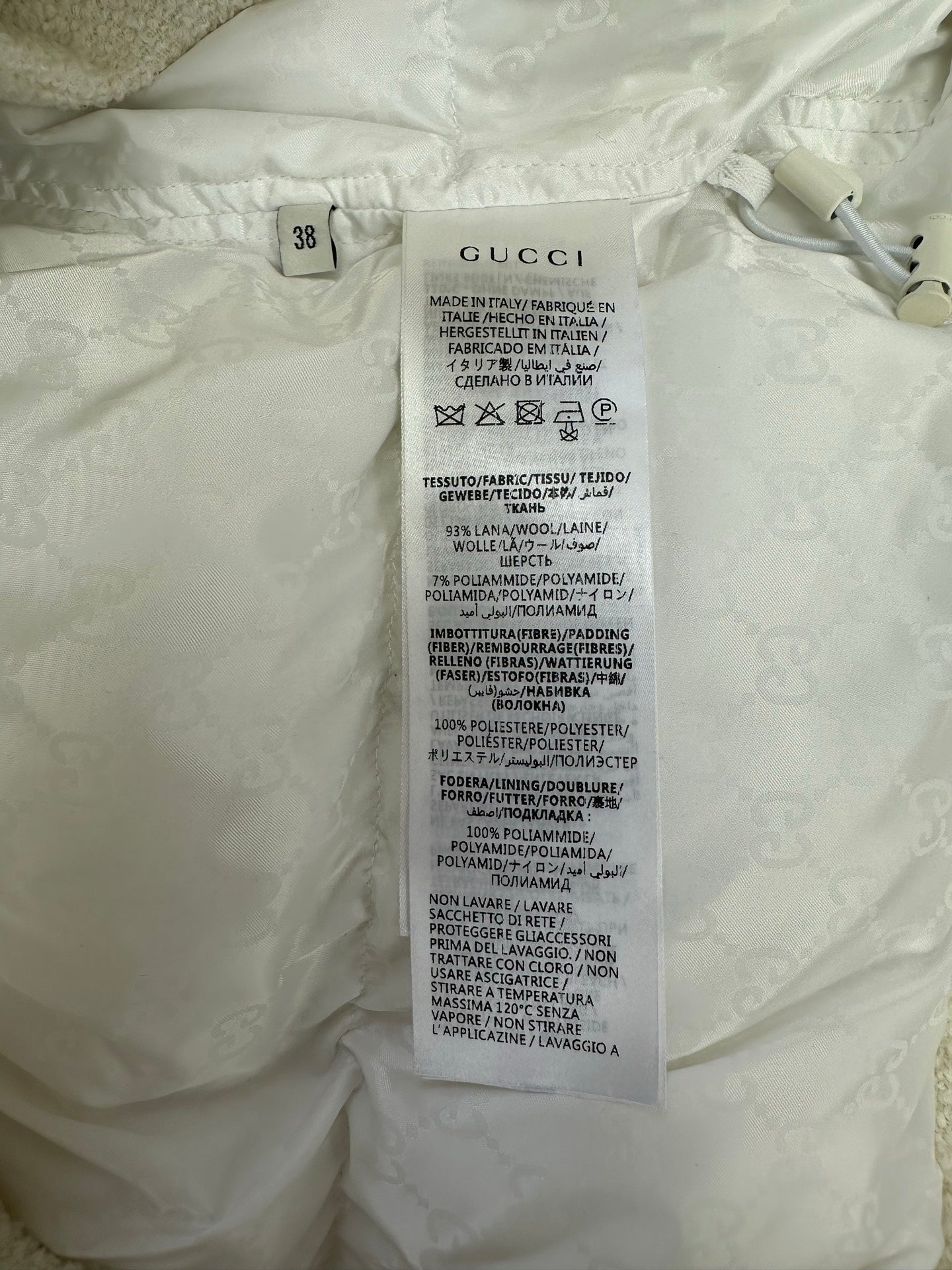 White garment care label with size 38 and fabric instructions