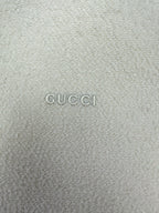 Off-white hoodie fabric with GUCCI logo text