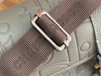 Dior men's bag strap close-up with metal buckle and woven webbing