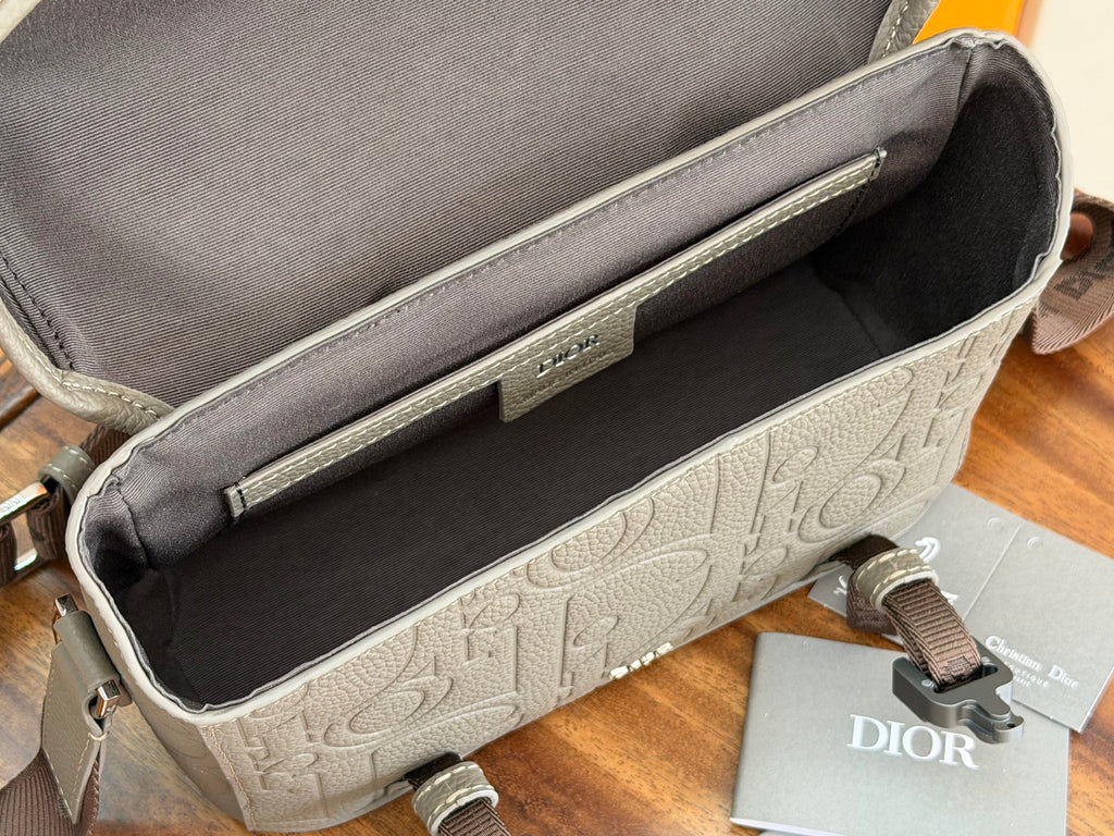 Dior men's bag interior view with dark lining and embossed logo base