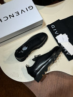 Givenchy black leather loafers pair with lace-up detail and chunky sole