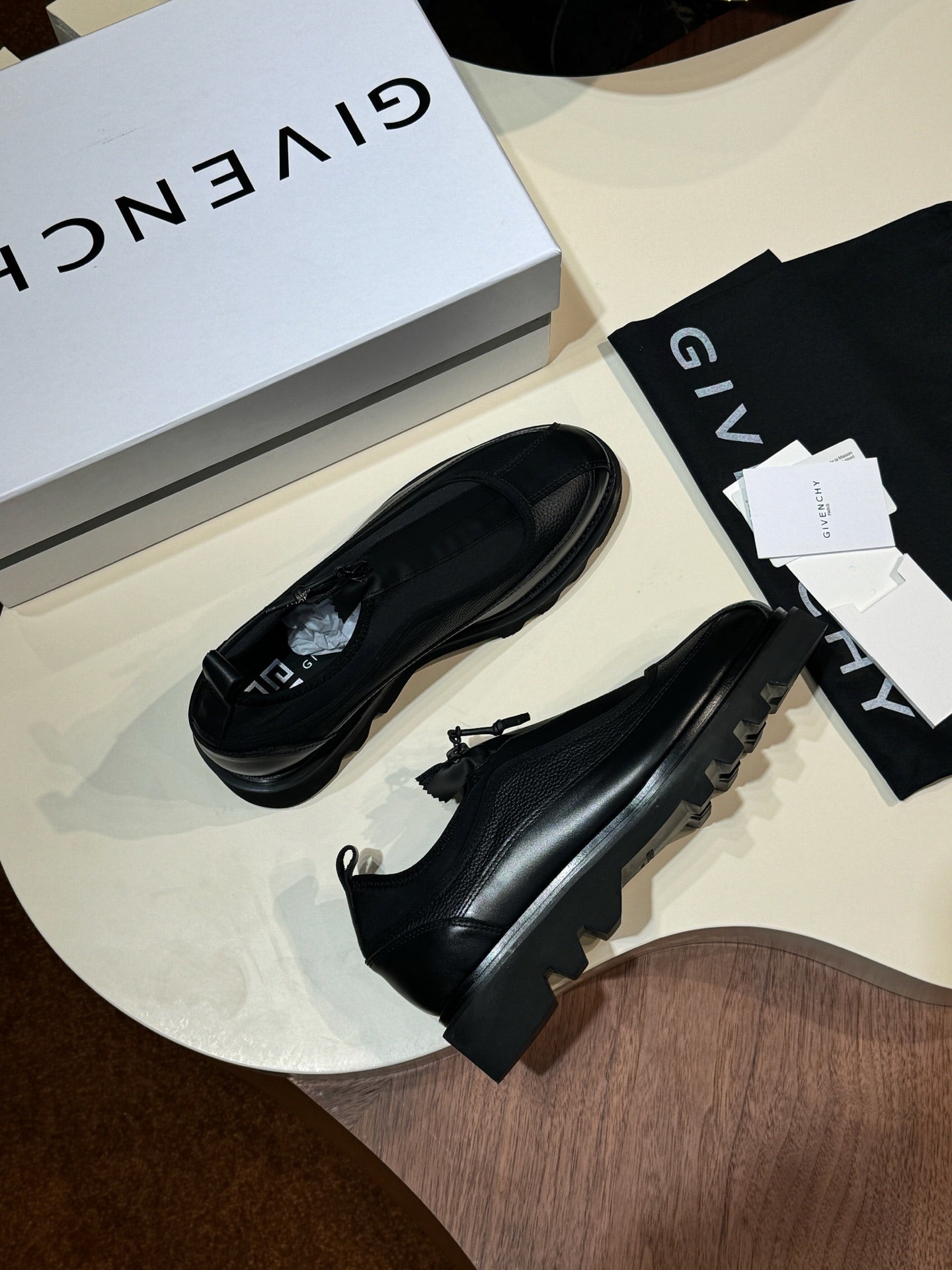 Givenchy black leather loafers pair with lace-up detail and chunky sole