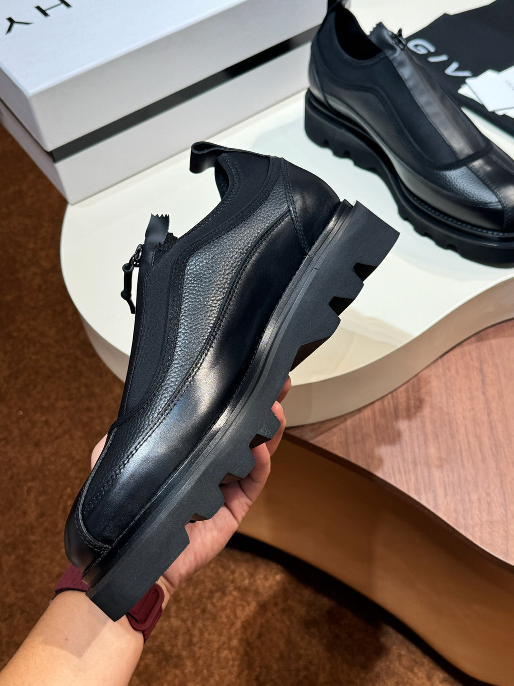 Givenchy black leather loafers with side strap and ridged outsole, front view