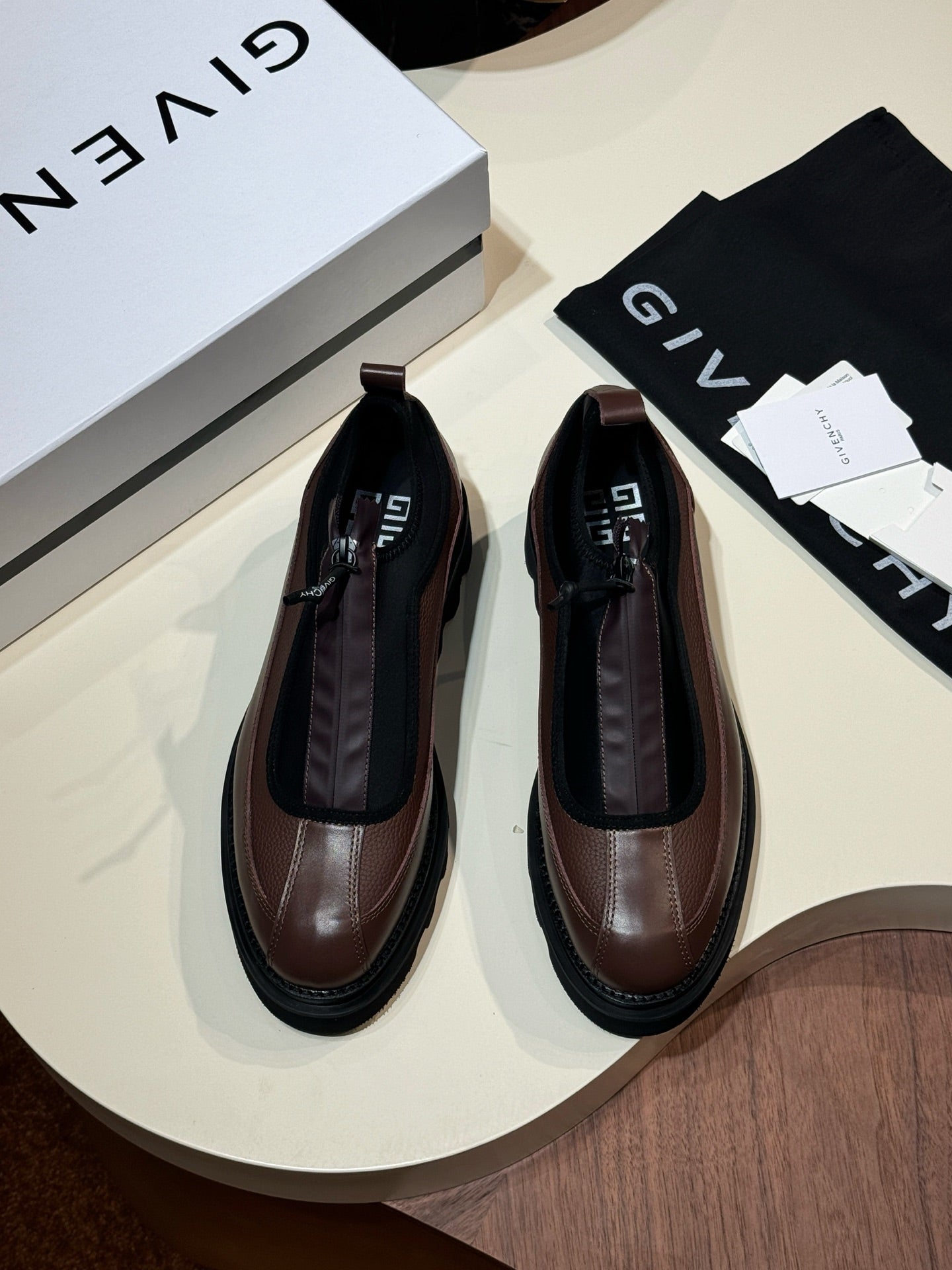 Givenchy lace-up leather shoes, brown and black, with visible laces and rounded toe.