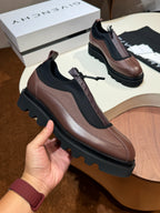Givenchy lace-up leather shoes in brown with black trim and thick lug sole.
