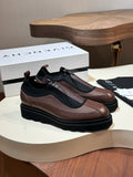 Givenchy lace-up leather shoes with brown upper, black side panels, and chunky sole.