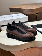 Givenchy lace-up leather shoes with brown upper, black side panels, and chunky sole.
